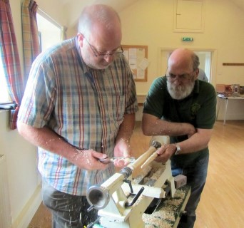 Fred holds the sample for John to follow